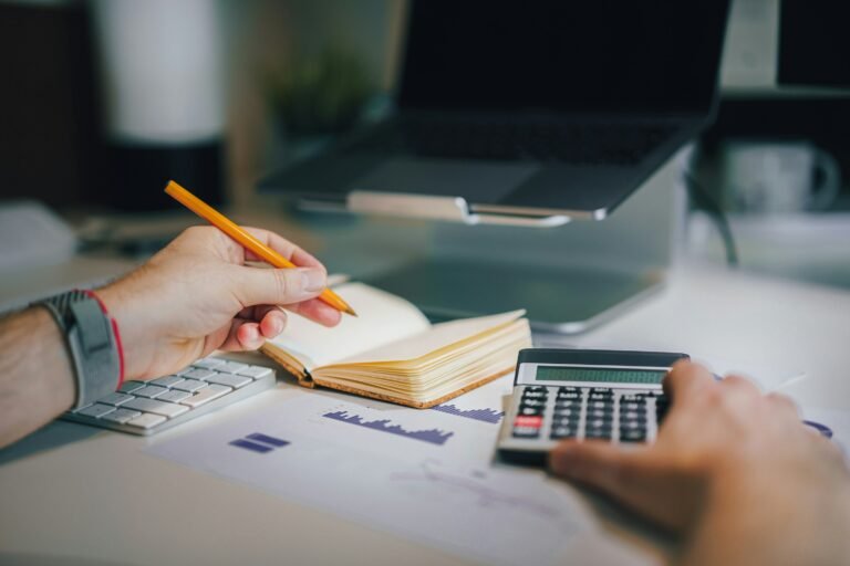 bookkeeper using a calculator and computer